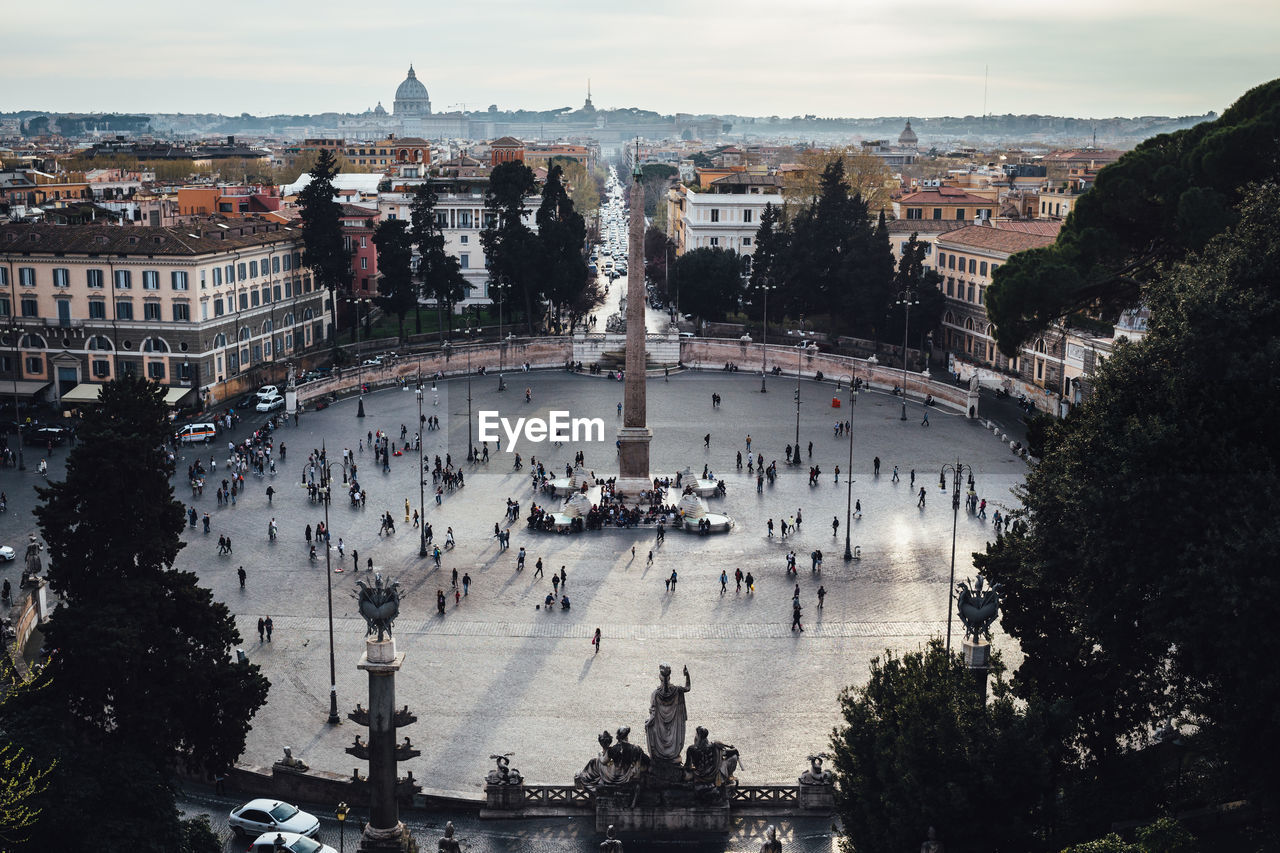 HIGH ANGLE VIEW OF PEOPLE IN CITY AT WATERFRONT