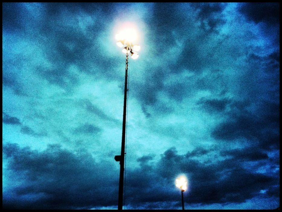 LOW ANGLE VIEW OF STREET LIGHTS AGAINST CLOUDY SKY