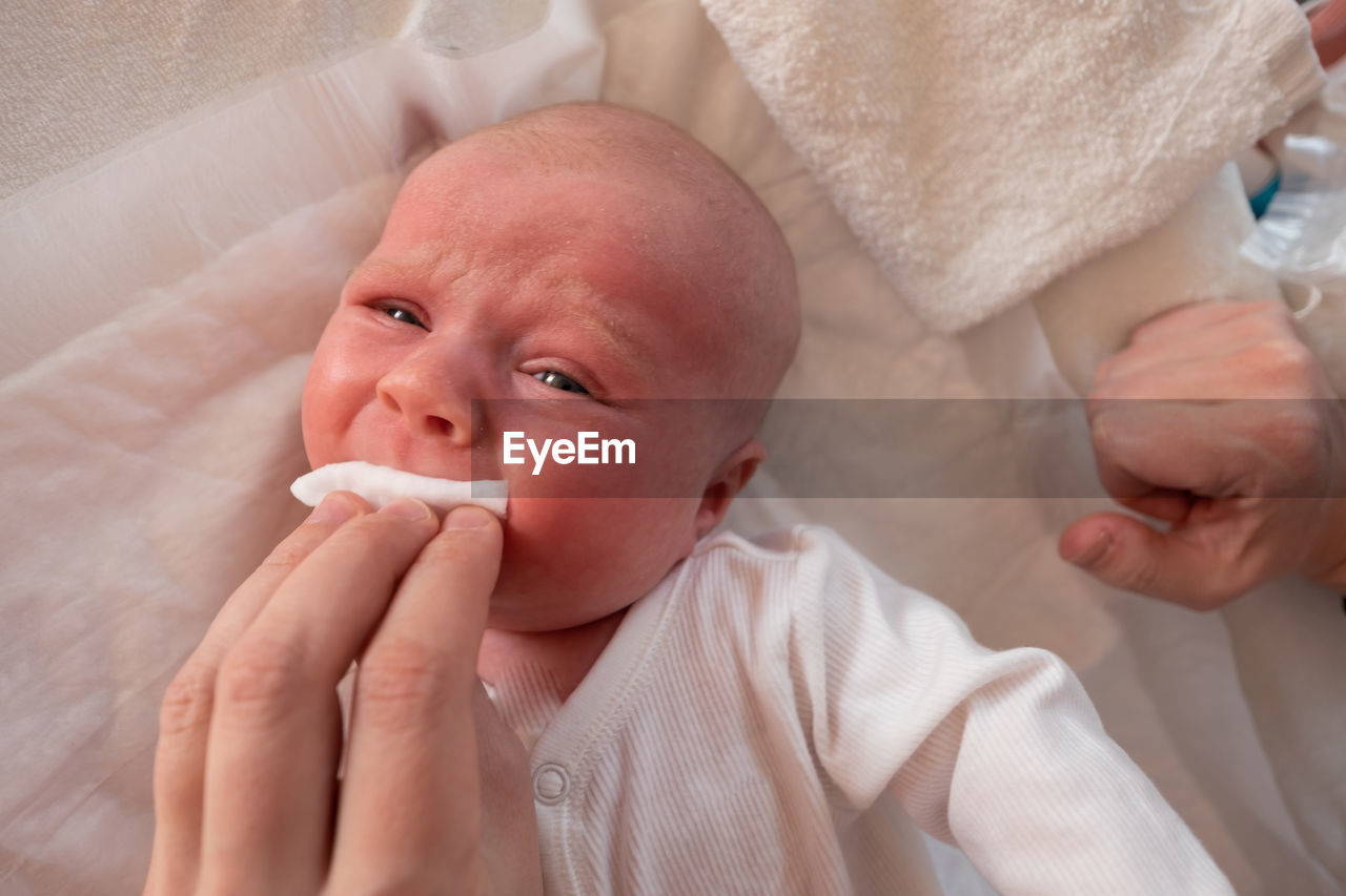baby, child, childhood, skin, beginnings, person, two people, indoors, newborn, innocence, adult, holding, portrait, family, cute, care, babyhood, hand, nose, men, emotion, parent, toddler, togetherness, headshot, healthcare and medicine, one parent, female, lifestyles, positive emotion, human face, lying down, eating, women, food and drink, food, love, front view, close-up