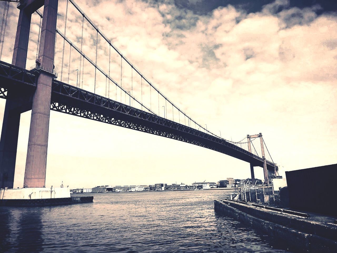 BRIDGE OVER RIVER AT SUNSET