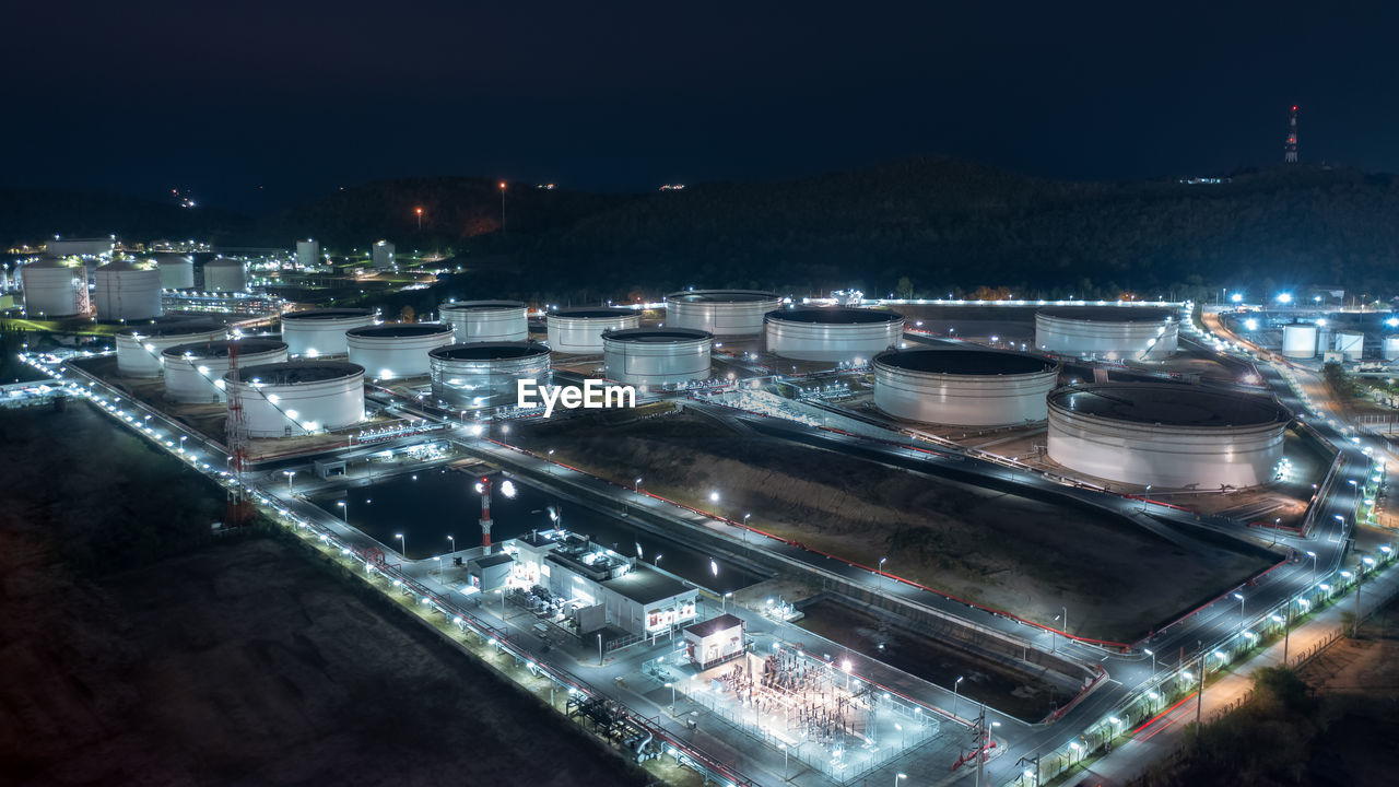  chemical industry storage tank and oil refinery in industrial plant at night over lighting,