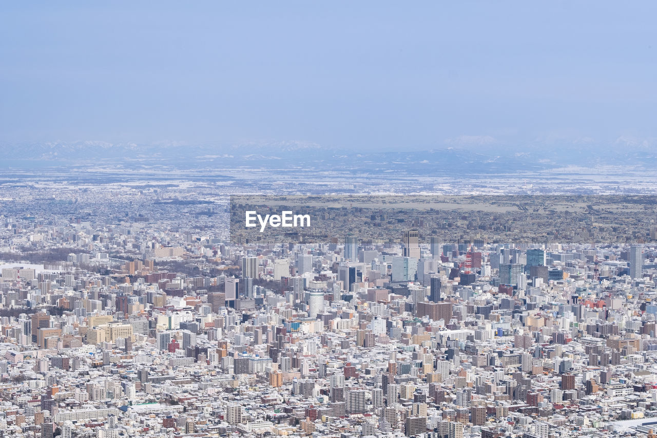 Aerial view of city against sky