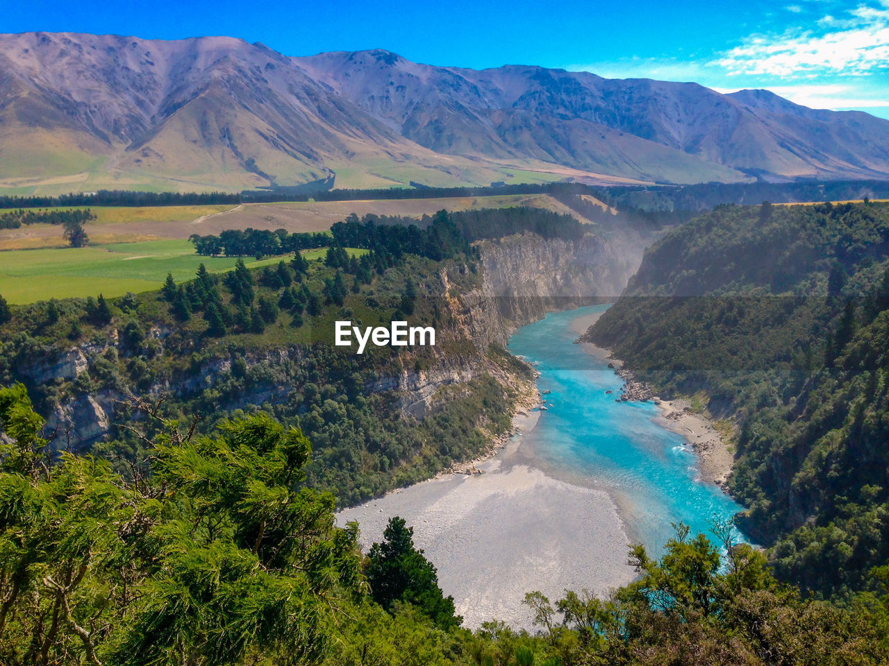 Scenic view of landscape and mountains against sky