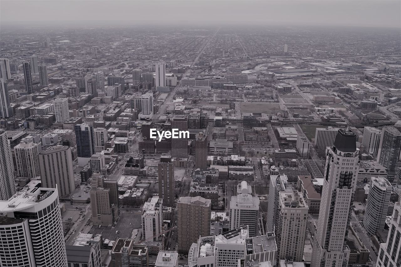 High angle view of modern buildings in city against sky