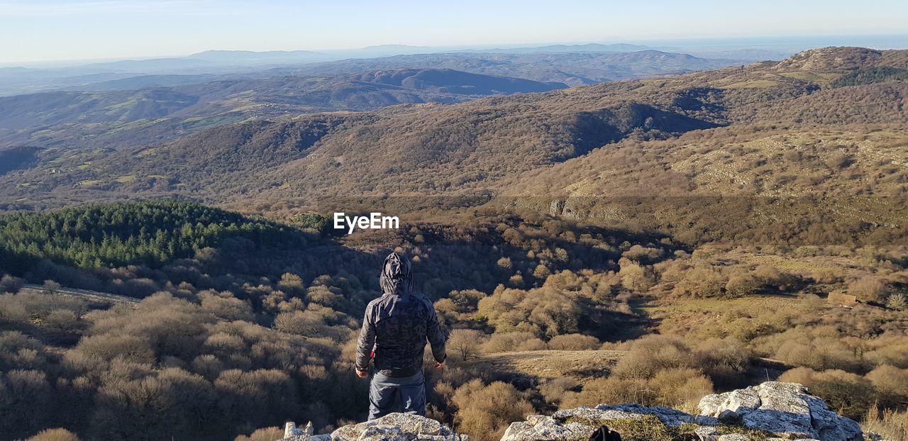 Rear view of man standing on mountain