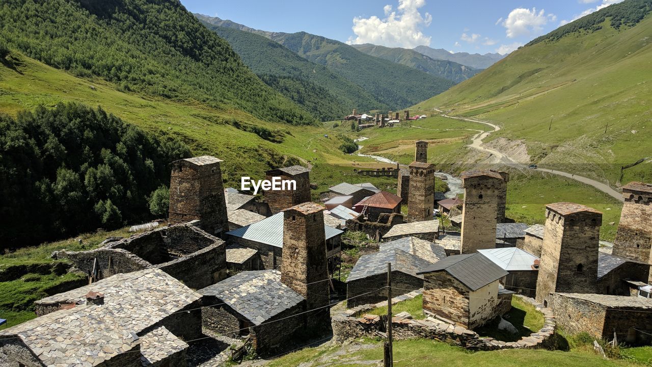 Scenic view of landscape against sky. traditional georgian towers.