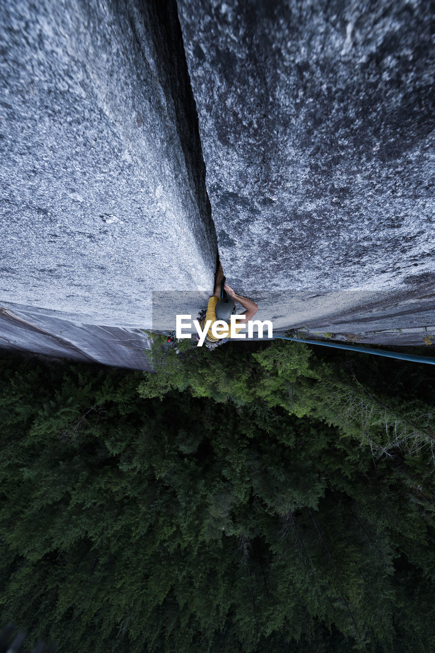 Man climbing wide off width climb on granite in squamish bc canada