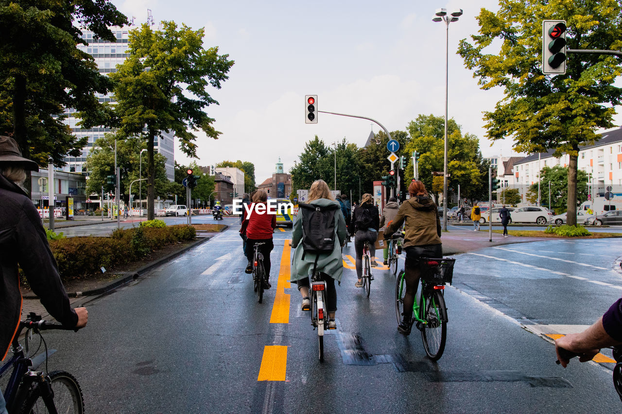 PEOPLE RIDING BICYCLE ON STREET