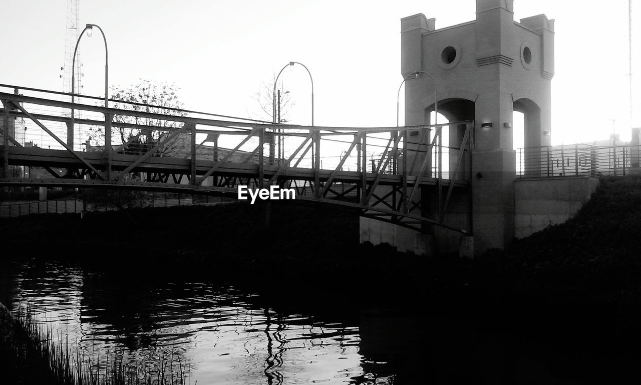 LOW ANGLE VIEW OF BRIDGE OVER RIVER AGAINST SKY