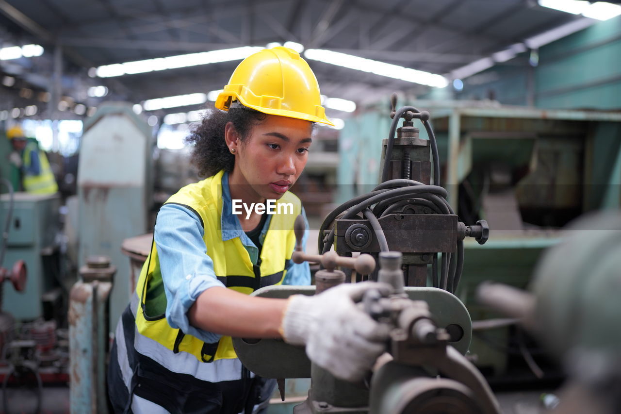 rear view of man working at factory