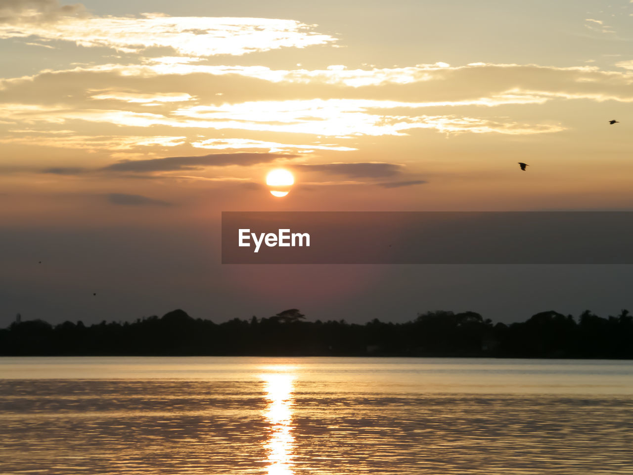 SCENIC VIEW OF SEA AGAINST ORANGE SKY DURING SUNSET