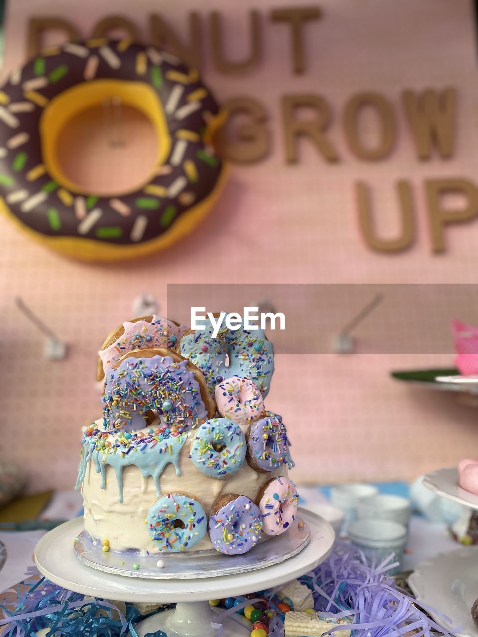 Close-up of a cake with doughnuts on table