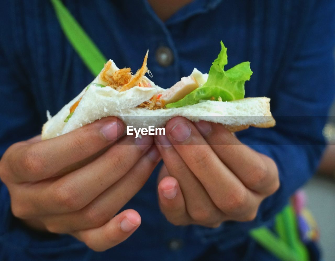 Midsection of woman holding sandwich