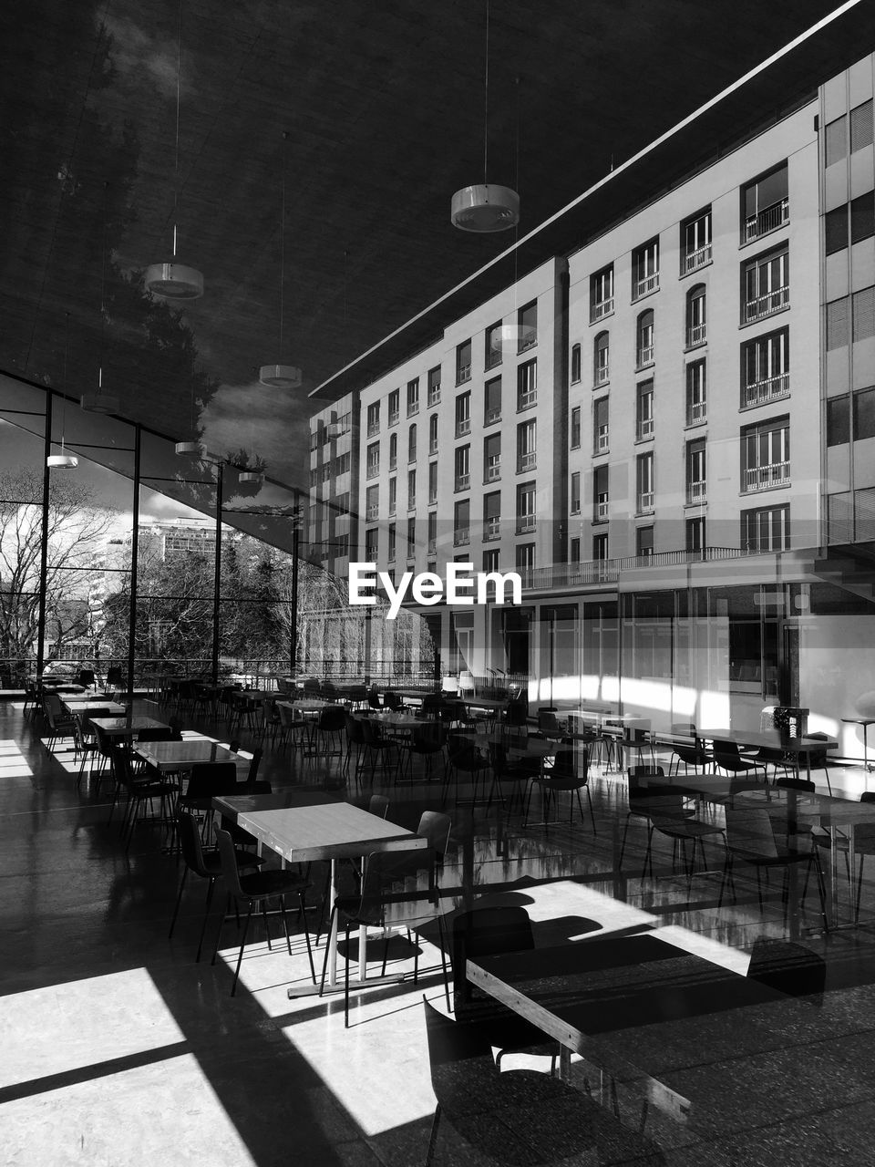 Empty chairs and table in restaurant outside building