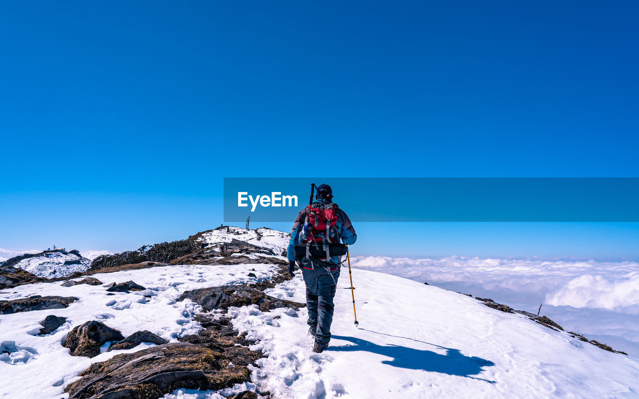 rear view of man skiing on snow