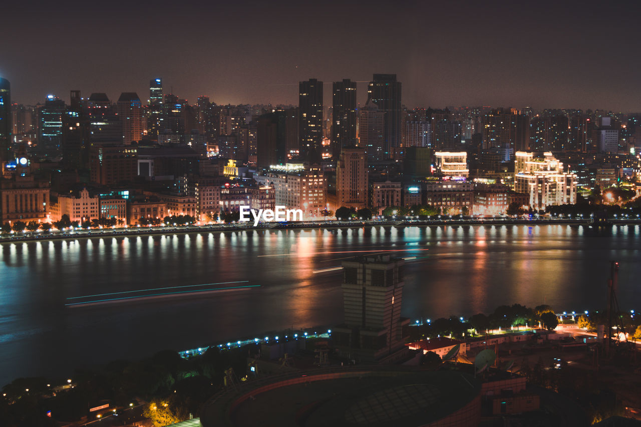 Illuminated city at waterfront