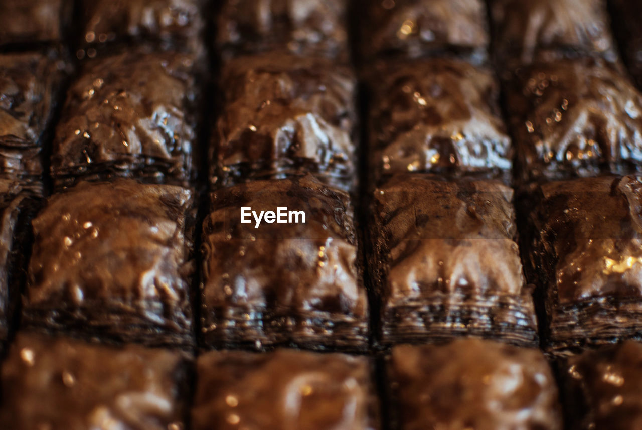 Full frame shot of baked pastry items on retail display at bakery store