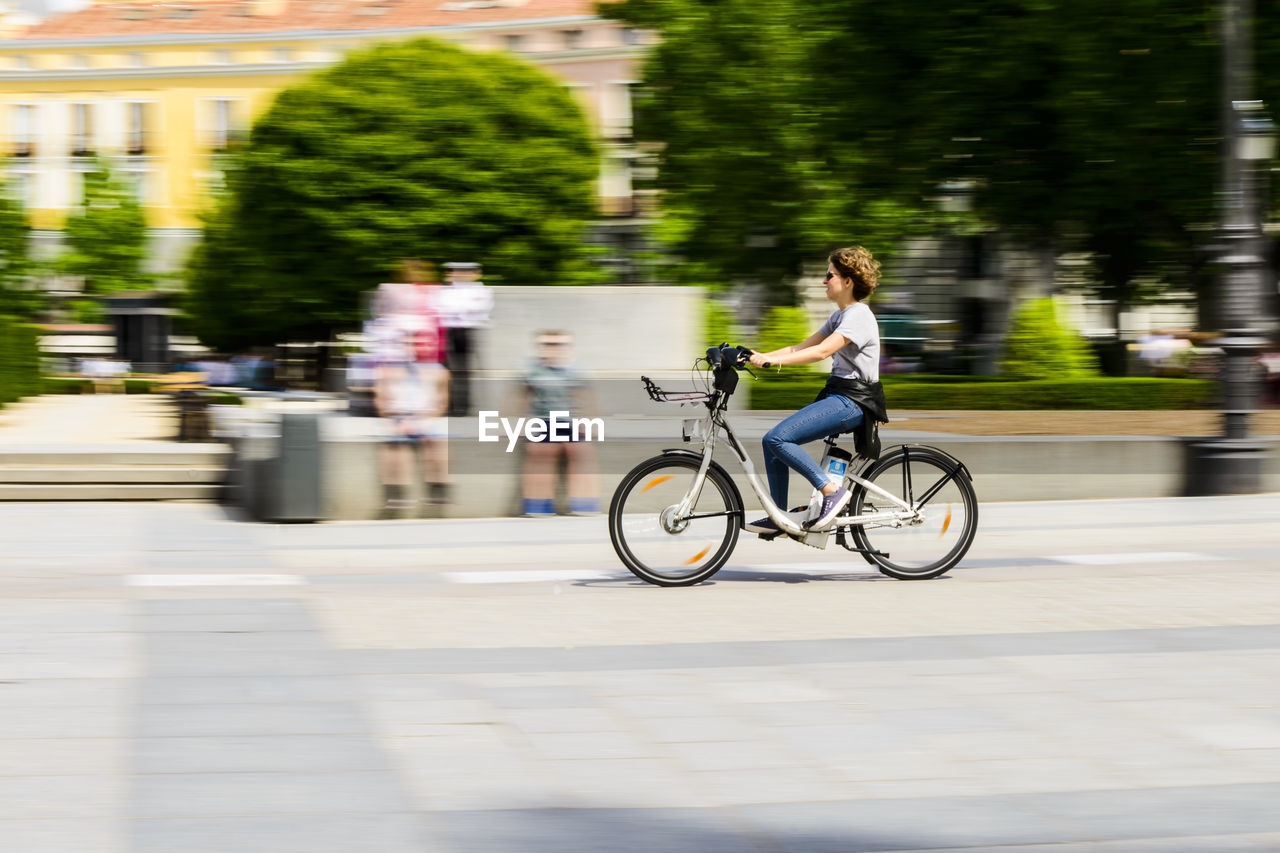 PERSON RIDING BICYCLE ON ROAD