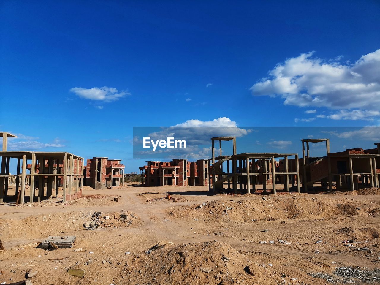 VIEW OF ABANDONED BUILDING ON BEACH AGAINST SKY