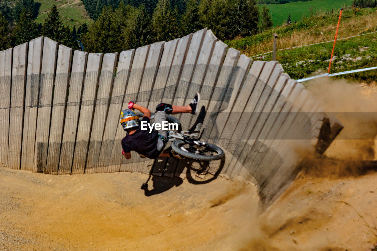 HIGH ANGLE VIEW OF PEOPLE RIDING MOTORCYCLE ON ROAD