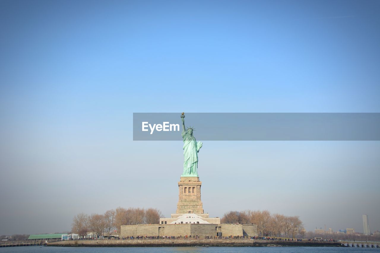 STATUE OF LIBERTY AGAINST CLEAR SKY DURING SUNRISE