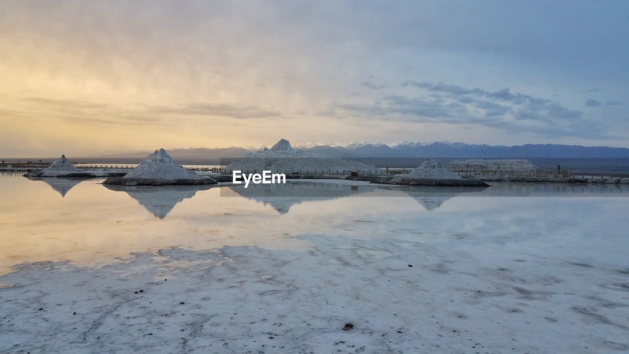 Scenic view of salt lake against sky