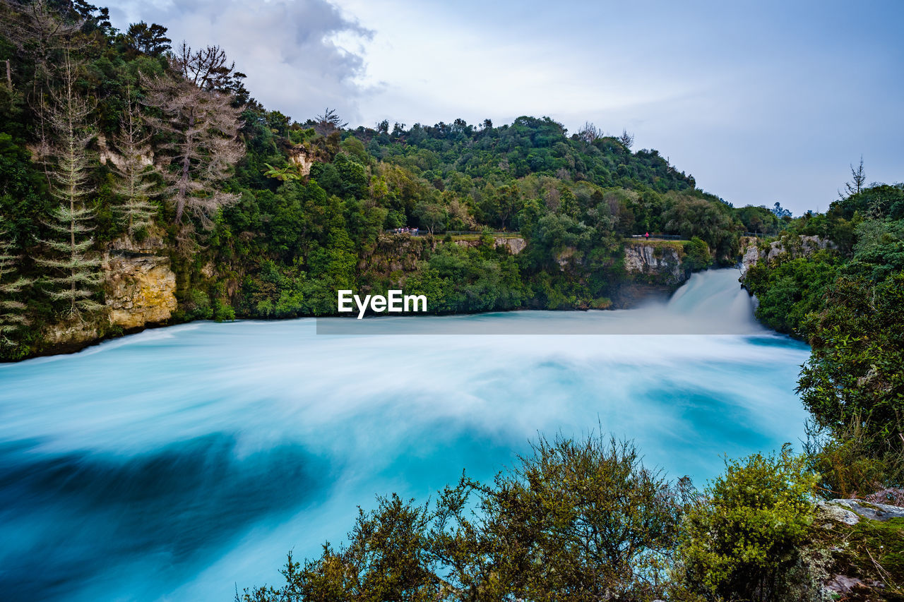 SCENIC VIEW OF WATERFALL IN FOREST