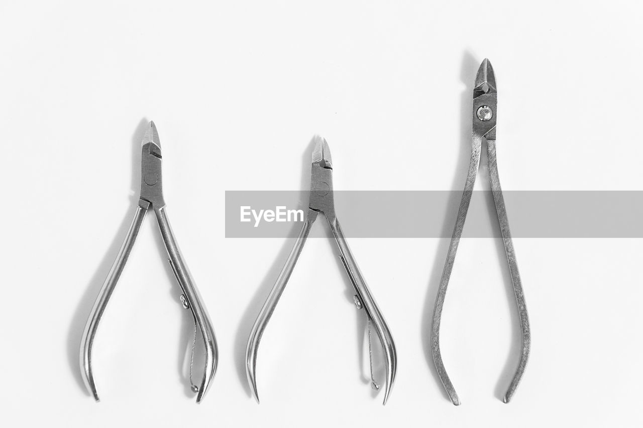 white background, indoors, studio shot, metal, no people, group of objects, cut out, work tool, steel, variation, close-up, equipment, tool, silver, kitchen utensil, eating utensil, still life