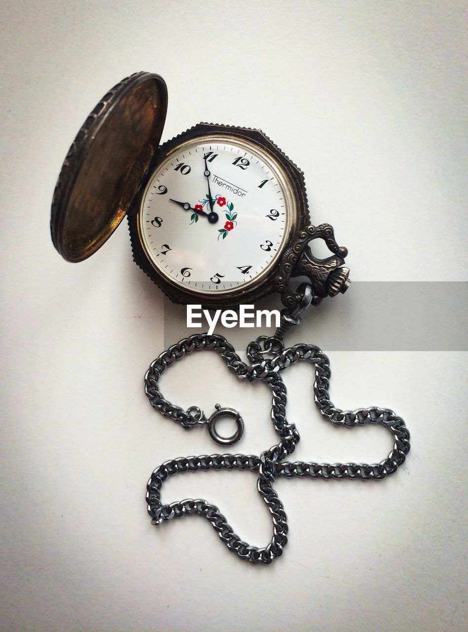 High angle view of pocket watch on table