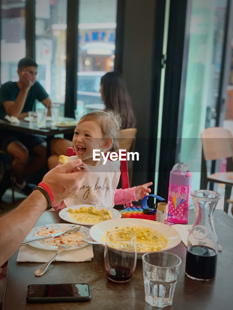 MIDSECTION OF WOMAN EATING FOOD