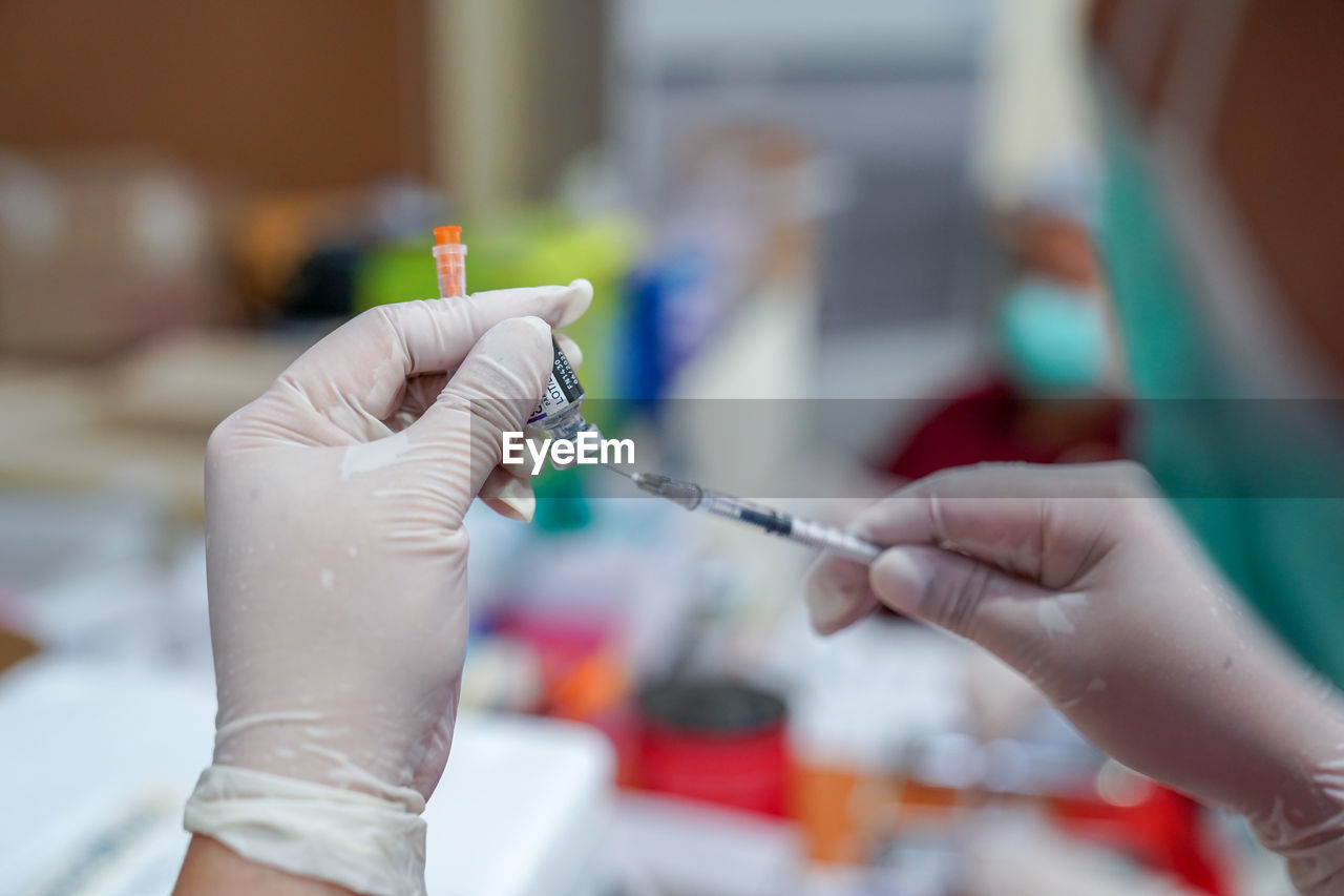 Doctor filling syringe with covid-19 vaccine doctor or scientist in the covid-19 medical vaccine 