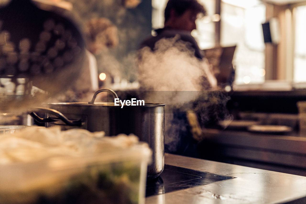 Container on stove in commercial kitchen