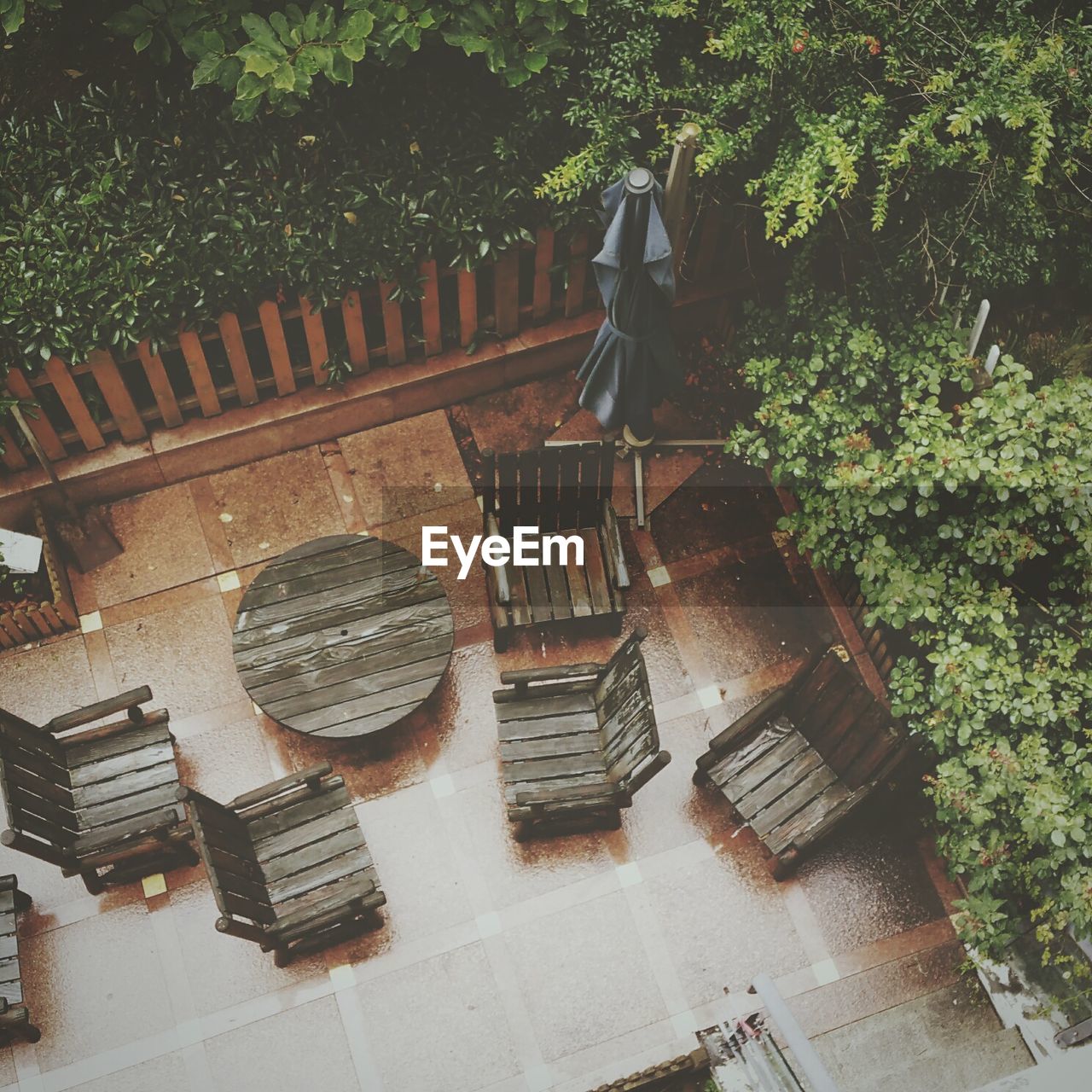 High angle view of empty wooden chair and table in yard