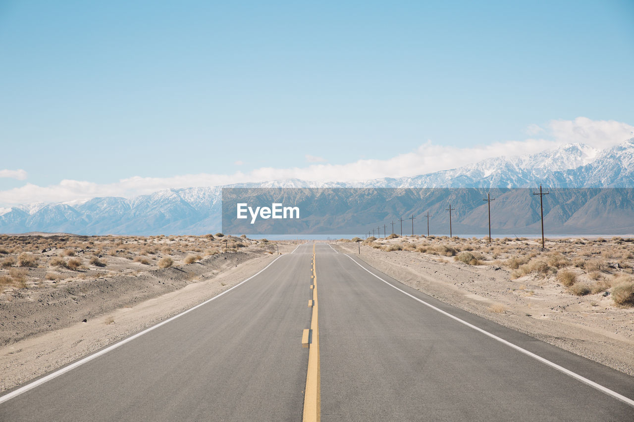 Road amidst landscape against sky