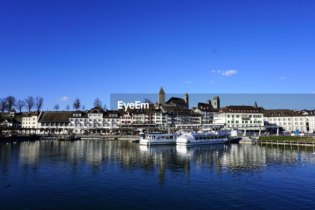 River by city against clear blue sky