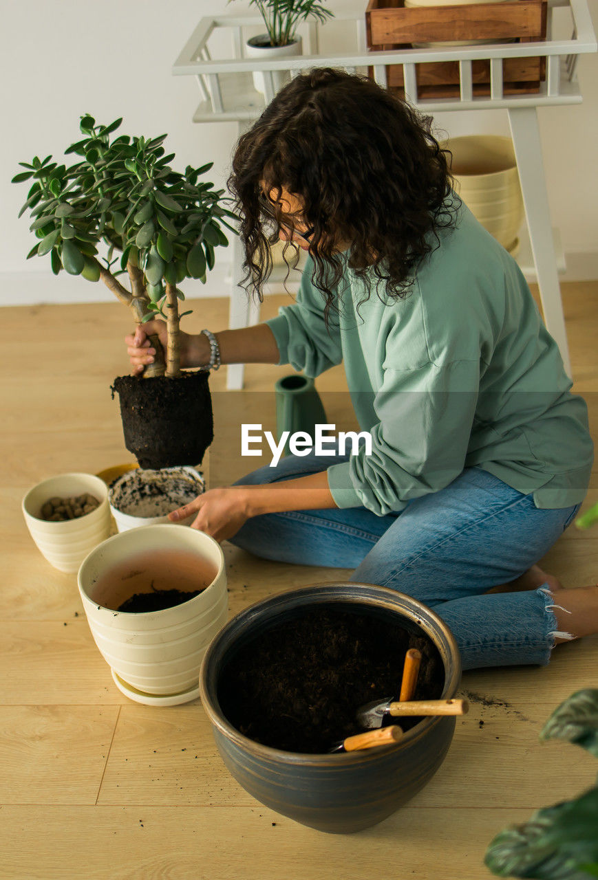 high angle view of woman gardening in mortar and pestle