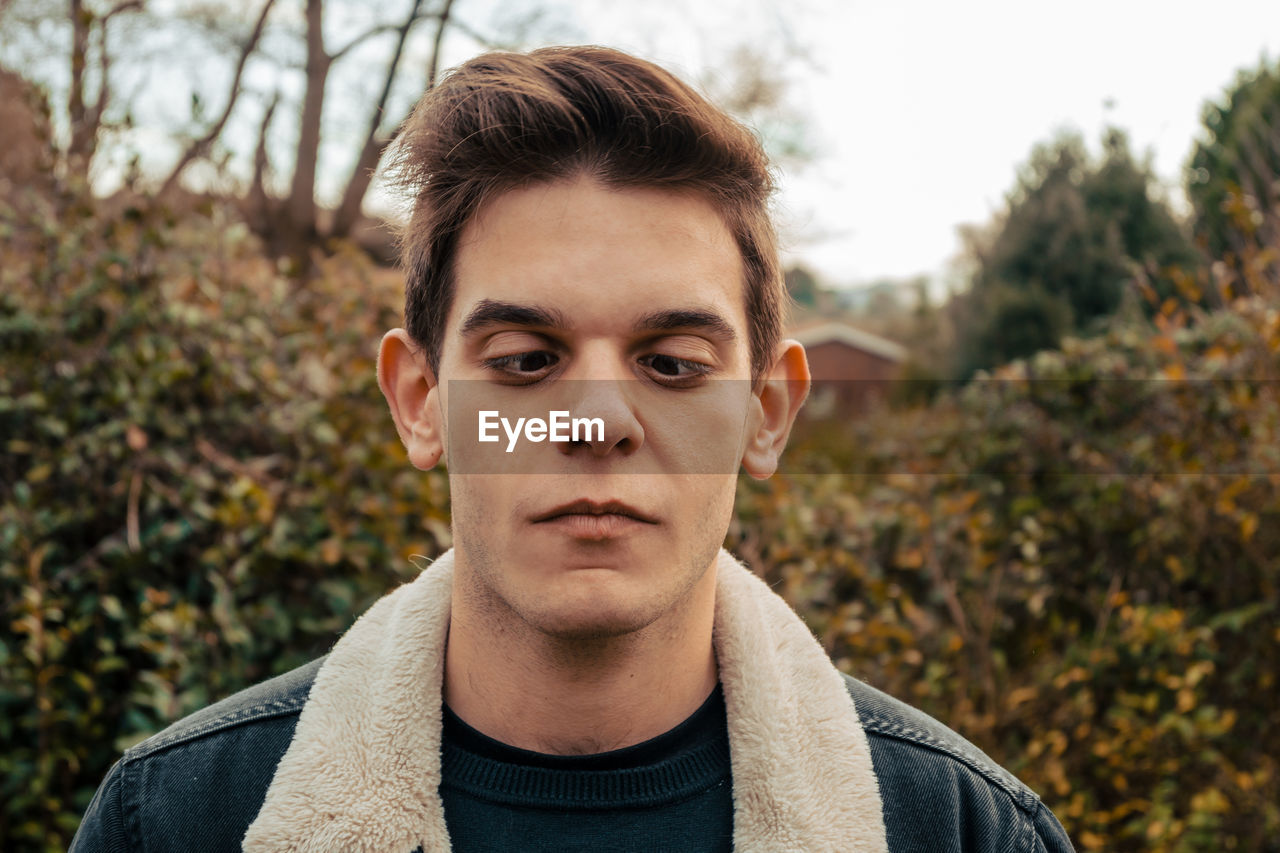 PORTRAIT OF YOUNG MAN IN AUTUMN