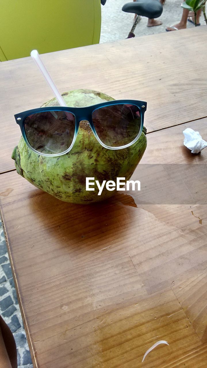 High angle view of sunglasses on coconut