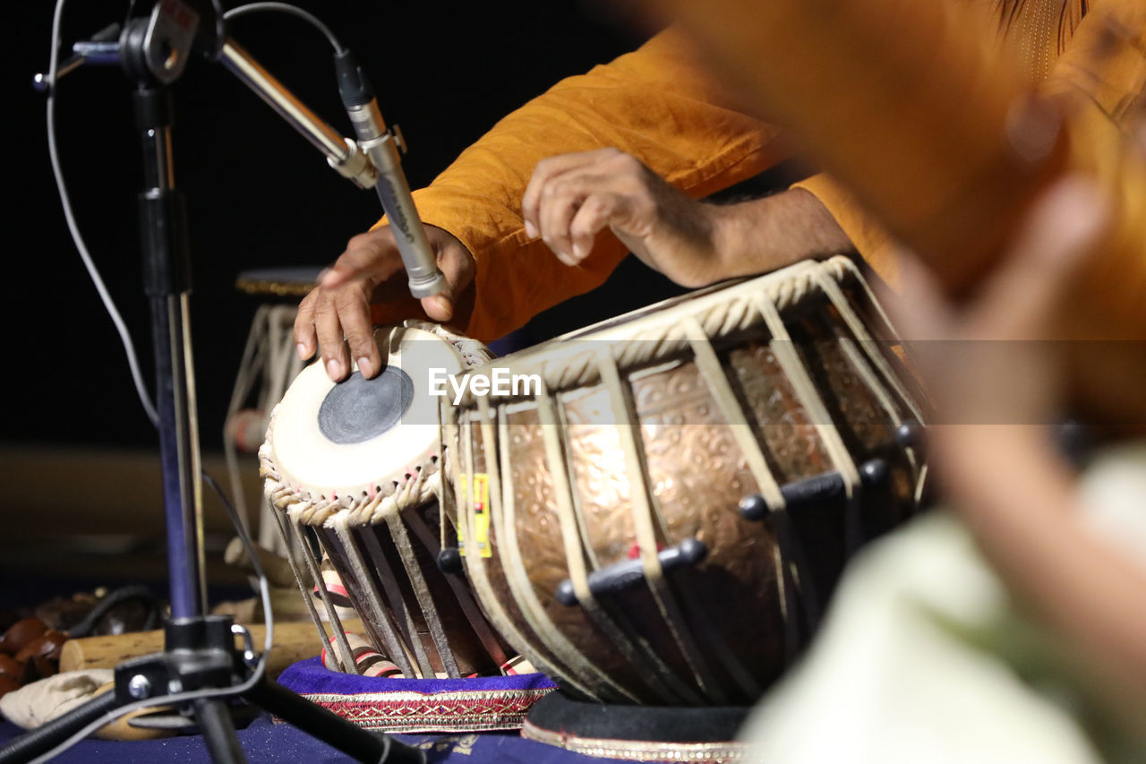 music, drums, musical instrument, percussion, drummer, musician, arts culture and entertainment, drum, performance, musical equipment, adult, one person, skill, membranophone, indoors, occupation, selective focus, hand, drum - percussion instrument, concert, men