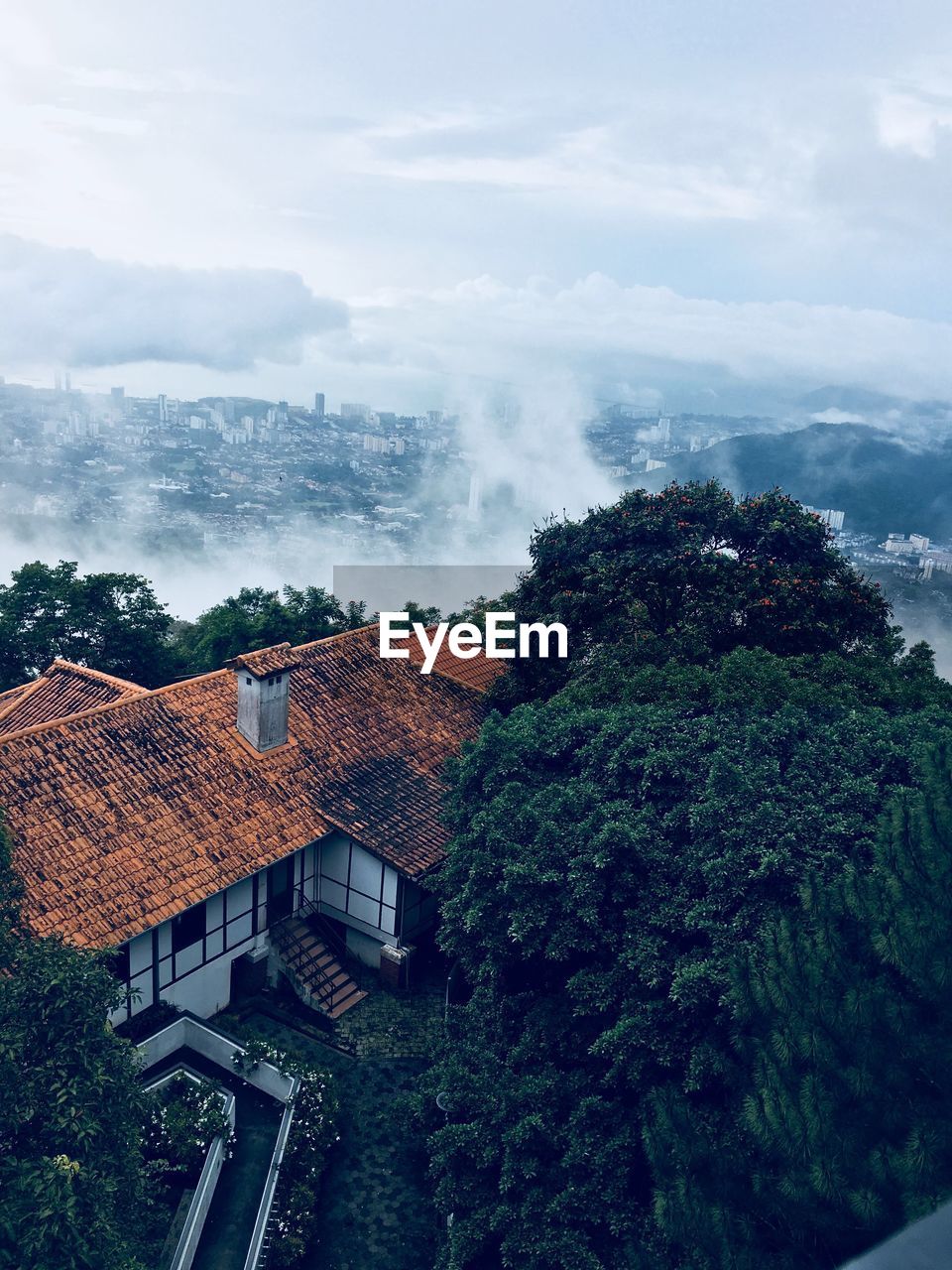 High angle view of houses and trees against sky