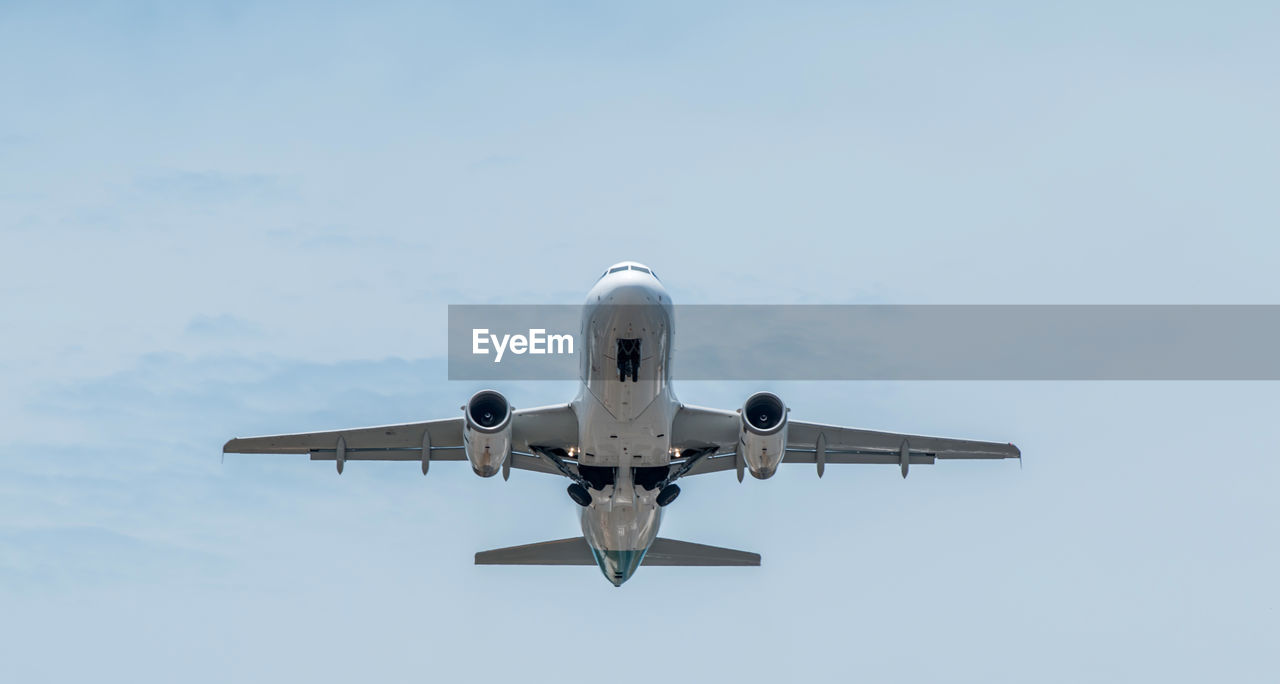 LOW ANGLE VIEW OF AIRPLANE IN SKY