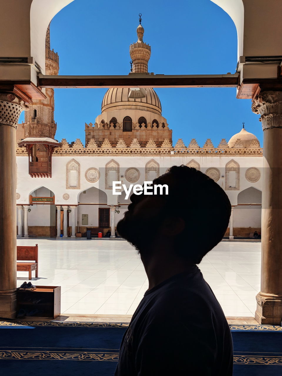 Silhouette man against mosque 