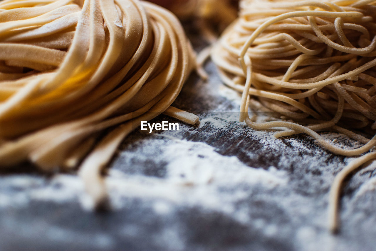 Close-up of pasta with flour on table