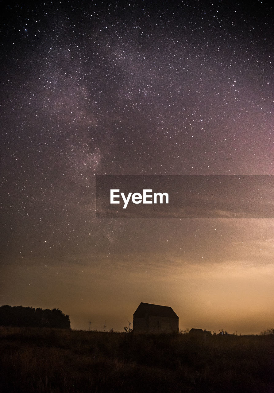 Scenic view of field against sky at night