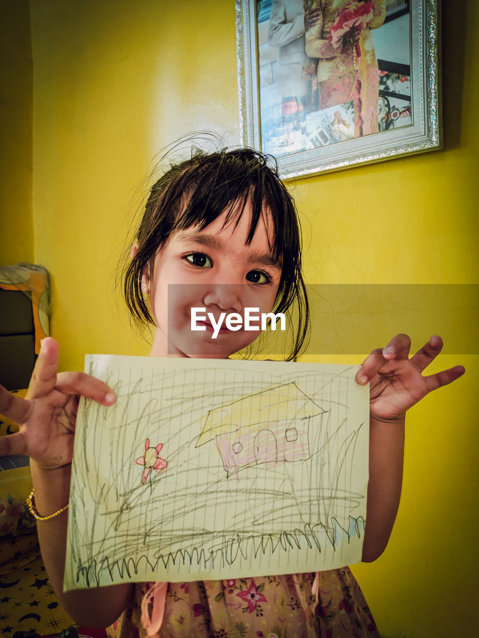 PORTRAIT OF CUTE GIRL HOLDING PAPER WITH YELLOW EYES