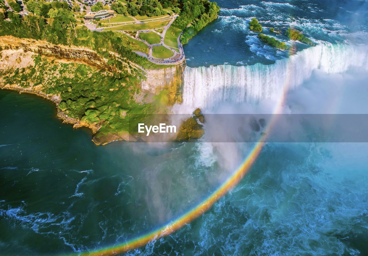 High angle aerial drone view of niagara falls with glorious  rainbow 