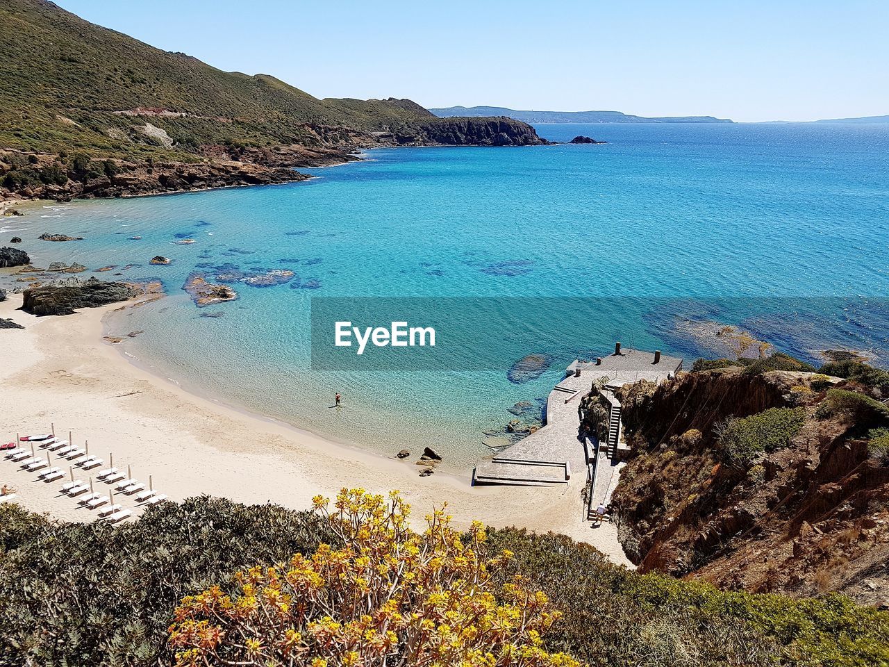 Scenic view of beach against blue sky