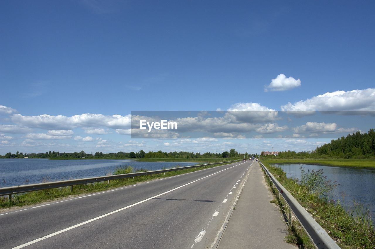 Road by landscape against sky