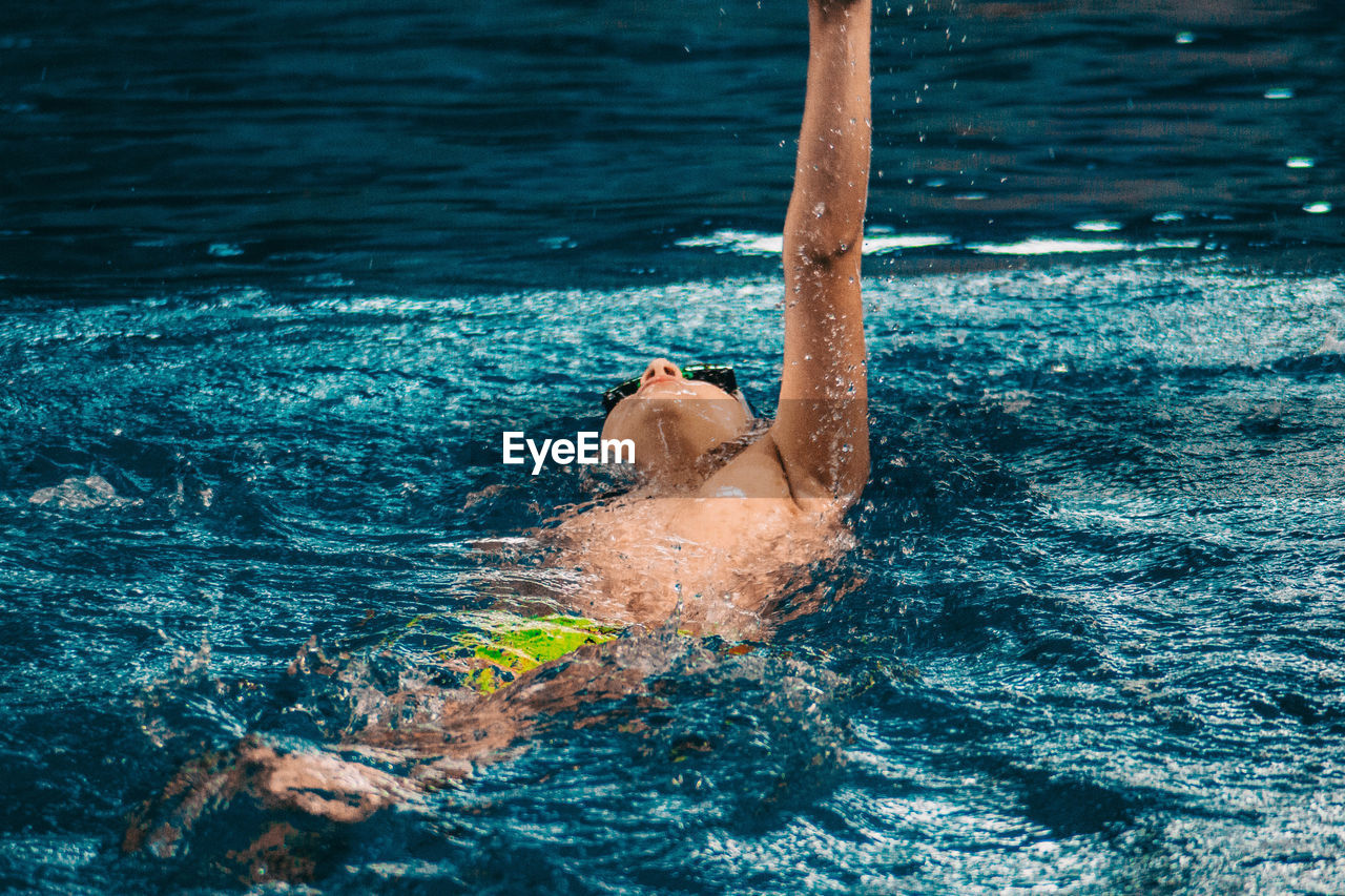 High angle view of boy swimming in pool