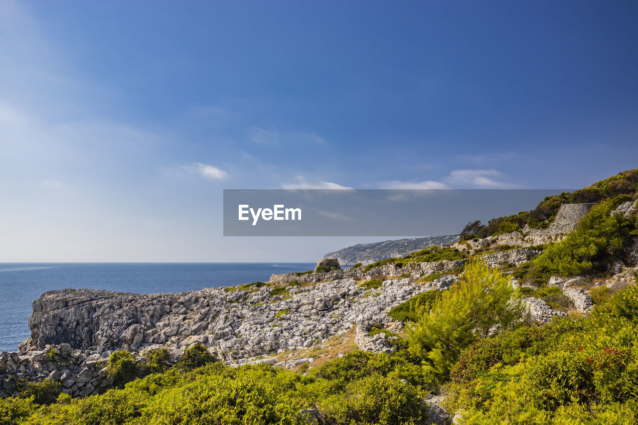 sky, sea, water, land, scenics - nature, landscape, beauty in nature, nature, coast, rock, plant, hill, beach, environment, cliff, cloud, tree, travel destinations, tranquility, no people, horizon over water, ocean, horizon, travel, shore, tranquil scene, blue, outdoors, day, tourism, architecture, coastline, vacation, non-urban scene, terrain, idyllic, body of water, trip